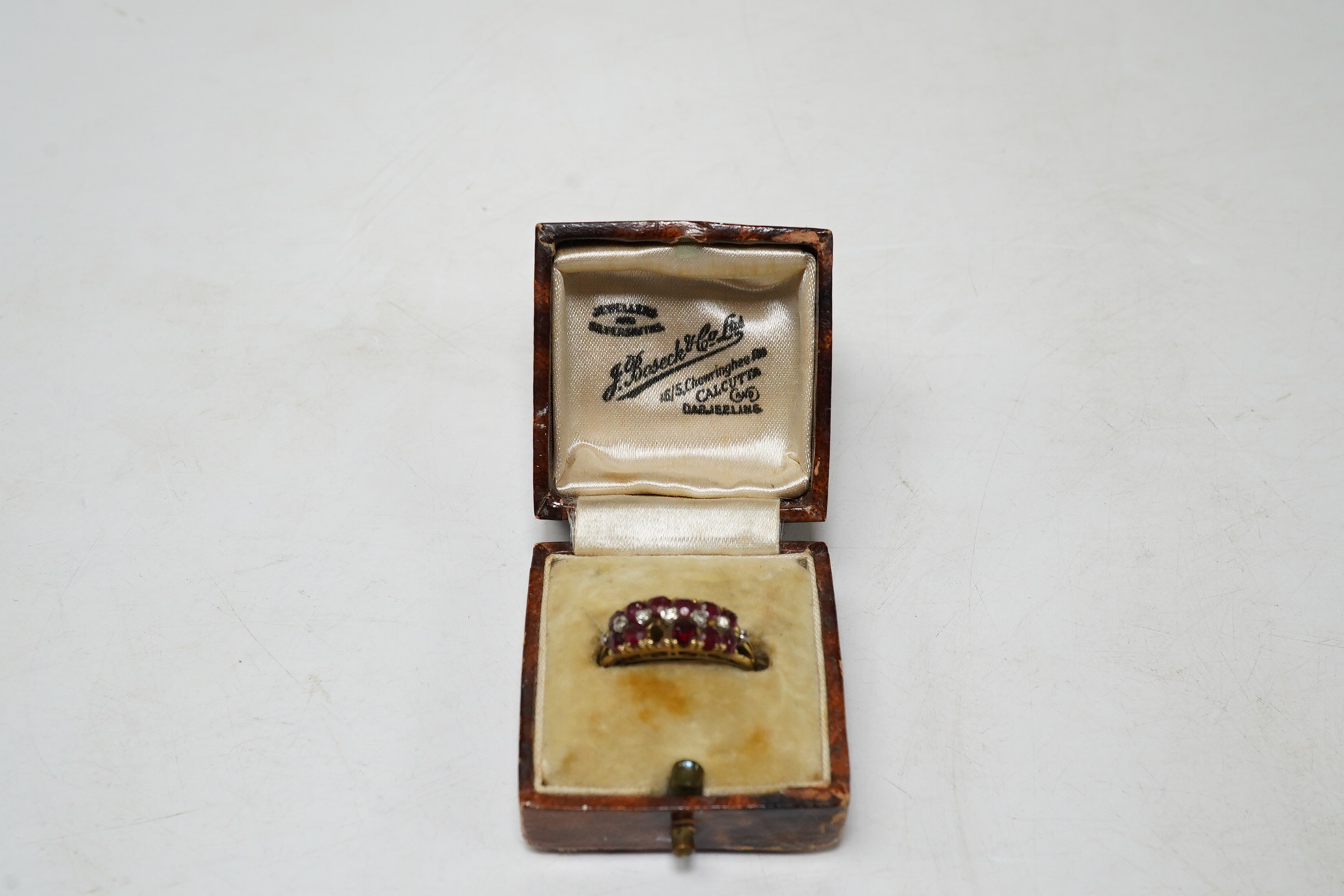An 18k ruby and diamond set dress ring, one ruby missing, size M, gross 3.7 grams
